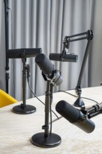 A professional podcast studio featuring dynamic microphones ready for a recording session.