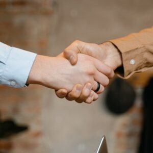 Close-up of a firm handshake symbolizing a business deal agreement.